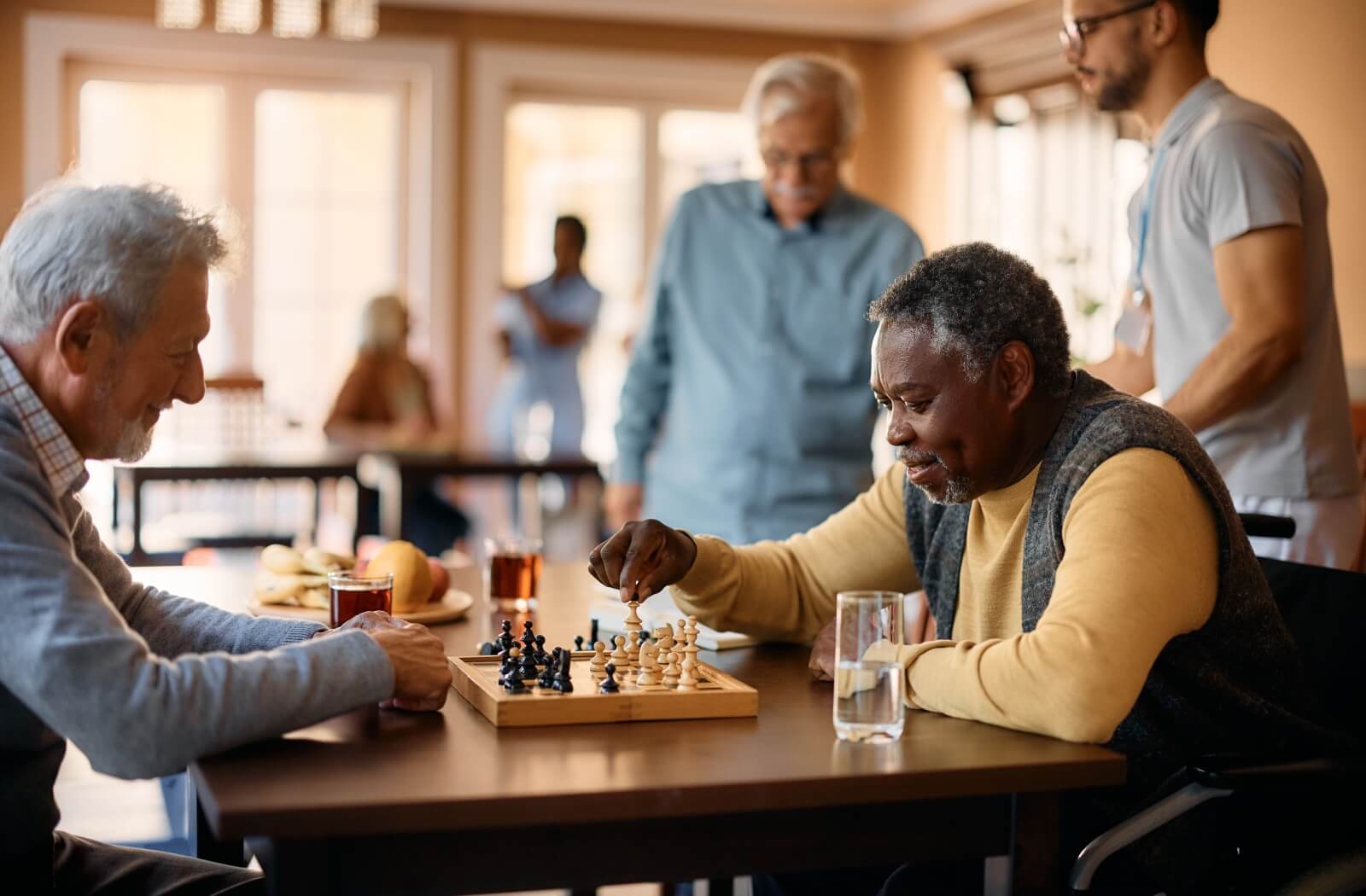 Joyful seniors deeply engaged in a game of chess at a residential care home
